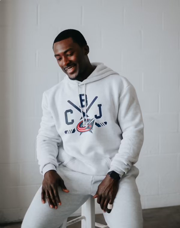 Man smiling while wearing Columbus Blue Jacket gear