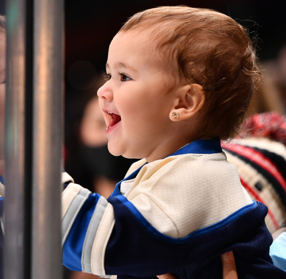 Baby smiling while wearing Columbus Blue Jacket gear